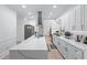 Bright kitchen features quartz countertops, stainless steel appliances and range hood, and white cabinetry at 1775 Potomac Ct, Lawrenceville, GA 30043