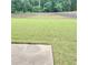 Large, grassy backyard featuring a fenced perimeter and ample space for outdoor activities at 3703 Liberty Sw Dr, Powder Springs, GA 30127