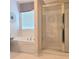 Bright bathroom boasts a separate tub, shower, and decorative wallpaper at 3703 Liberty Sw Dr, Powder Springs, GA 30127