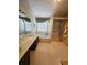 Bathroom with a double sink vanity, separate shower and bathtub, and decorative wallpaper at 3703 Liberty Sw Dr, Powder Springs, GA 30127
