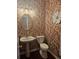 Stylish powder room with unique wallpaper and a pedestal sink at 3703 Liberty Sw Dr, Powder Springs, GA 30127