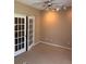 Bedroom featuring double french doors, neutral carpet and ceiling fan at 3703 Liberty Sw Dr, Powder Springs, GA 30127