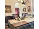 Elegant dining room features decorative wallpaper, chandelier, and stylish furnishings creating a warm and inviting atmosphere at 3703 Liberty Sw Dr, Powder Springs, GA 30127