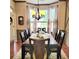 Traditional dining room with hardwood floors, complemented by a chandelier, a large window and sophisticated decor at 3703 Liberty Sw Dr, Powder Springs, GA 30127