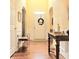 Welcoming foyer with hardwood floors, archways, a charming table and decorative wreath on the door at 3703 Liberty Sw Dr, Powder Springs, GA 30127