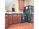 Functional kitchen featuring wood cabinets, black appliances, and an efficient layout, perfect for cooking at 3703 Liberty Sw Dr, Powder Springs, GA 30127
