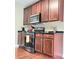 Well-equipped kitchen with dark wood cabinetry, stainless steel oven, and ample counter space for meal preparation at 3703 Liberty Sw Dr, Powder Springs, GA 30127