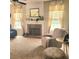Comfortable living room with a brick fireplace, soft carpet, and large windows, offering a cozy living space at 3703 Liberty Sw Dr, Powder Springs, GA 30127