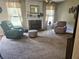 Cozy living room featuring a fireplace, neutral carpet, and comfortable seating at 3703 Liberty Sw Dr, Powder Springs, GA 30127