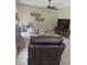 Comfortable living room featuring neutral carpet, ceiling fan, and entertainment center at 3703 Liberty Sw Dr, Powder Springs, GA 30127