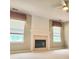 Bright living room featuring a modern fireplace and large windows, creating a warm and inviting atmosphere at 3703 Liberty Sw Dr, Powder Springs, GA 30127