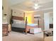 Spacious main bedroom features a four-poster bed, tray ceiling, and ensuite bathroom at 3703 Liberty Sw Dr, Powder Springs, GA 30127