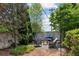 Inviting backyard patio with stylish seating area, fire pit, string lights, and privacy wall at 6925 Colfax Ave, Cumming, GA 30040