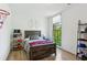 Well-lit bedroom with a sports theme, hardwood floors, and a bright window at 6925 Colfax Ave, Cumming, GA 30040
