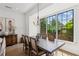 Dining room with large windows, wood table with seating for six, sideboard, and hardwood floors at 6925 Colfax Ave, Cumming, GA 30040