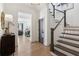 Entryway with staircase and view of the living room, showcasing hardwood floors at 6925 Colfax Ave, Cumming, GA 30040