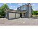 Charming home featuring a two-car garage and outdoor grill, all set on a gravel driveway at 6925 Colfax Ave, Cumming, GA 30040