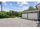 Detached two-car garage with ample driveway space for parking and outdoor grill at 6925 Colfax Ave, Cumming, GA 30040