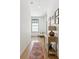 Light hallway with wooden floors, a console table, and a cozy chair near the window at 6925 Colfax Ave, Cumming, GA 30040