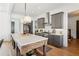 Bright kitchen features stainless steel appliances, gray cabinets, marble countertops and a large center island at 6925 Colfax Ave, Cumming, GA 30040