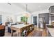 Kitchen and living room featuring a large center island, stainless steel appliances, and open layout at 6925 Colfax Ave, Cumming, GA 30040