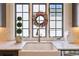 Farmhouse sink with gooseneck faucet under a large window with fall-themed wreath and green topiaries at 6925 Colfax Ave, Cumming, GA 30040