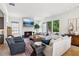 Spacious living room with fireplace, hardwood floors, and abundant natural light at 6925 Colfax Ave, Cumming, GA 30040