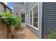 Side yard of a home with gray siding and a brick accent wall at 6925 Colfax Ave, Cumming, GA 30040