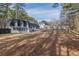 Large, grassy backyard featuring a two-story home with a black roof and white painted brick at 7020 Camp Valley Rd, Riverdale, GA 30296
