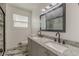 Bathroom featuring double sink vanity with granite countertop and tiled floors at 7020 Camp Valley Rd, Riverdale, GA 30296