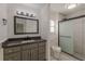 Modern bathroom featuring gray vanity, marble floors, and glass-enclosed shower at 7020 Camp Valley Rd, Riverdale, GA 30296