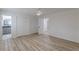 Open bedroom showcasing wood-look floors with a view of a bathroom at 7020 Camp Valley Rd, Riverdale, GA 30296