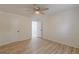 Bedroom with ceiling fan, light wood-look floors, and access to another room at 7020 Camp Valley Rd, Riverdale, GA 30296