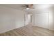 Bedroom with wood-look floors, a ceiling fan, and closet, and a view to hallway at 7020 Camp Valley Rd, Riverdale, GA 30296