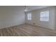 Bright bedroom featuring wood-look flooring and ample natural light from two windows at 7020 Camp Valley Rd, Riverdale, GA 30296