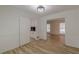 Dining room featuring hardwood floors and white cabinets with a direct passage to the kitchen at 7020 Camp Valley Rd, Riverdale, GA 30296