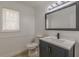 Half bathroom featuring a vanity with marble top and a toilet with a closed lid at 7020 Camp Valley Rd, Riverdale, GA 30296