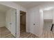 Hallway with doors leading to rooms, featuring wood-look floors and neutral walls at 7020 Camp Valley Rd, Riverdale, GA 30296