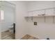Convenient laundry room with storage shelving, located next to a half bathroom at 7020 Camp Valley Rd, Riverdale, GA 30296