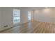 Bright living room featuring newly installed light wood floors and fresh neutral paint at 7020 Camp Valley Rd, Riverdale, GA 30296