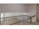 Loft overlooking open floor plan with clean white walls and contrasting railing at 7020 Camp Valley Rd, Riverdale, GA 30296