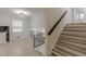 Hallway view with wood steps, and black metal handrail to living spaces at 7020 Camp Valley Rd, Riverdale, GA 30296