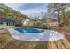 Backyard showcasing an in-ground pool with metal ladder entry surrounded by a concrete deck at 7020 Camp Valley Rd, Riverdale, GA 30296