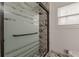 Modern shower with glass door and marble-look tile surround in bathroom at 7020 Camp Valley Rd, Riverdale, GA 30296