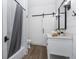 Cozy bathroom featuring a shower with a gray curtain, a vanity, and ship lap walls at 958 Crew Sw St, Atlanta, GA 30315