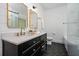 Modern bathroom features double vanity, hexagon tile floor, and glass-enclosed shower at 958 Crew Sw St, Atlanta, GA 30315