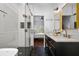 Elegant bathroom with double vanity, hexagon tile, glass shower, and view of the bedroom at 958 Crew Sw St, Atlanta, GA 30315