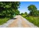 Gravel drive leading to property, with trees and greenery on either side at 958 Crew Sw St, Atlanta, GA 30315