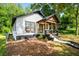View of the front exterior displaying charming curb appeal, a covered porch, and well-maintained landscaping at 958 Crew Sw St, Atlanta, GA 30315