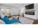 Cozy living area with a fireplace, mounted TV, sleek furniture, and open access to other living spaces at 958 Crew Sw St, Atlanta, GA 30315